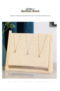 Linen texture necklace display stand with bamboo base and three hanging jewelry pieces