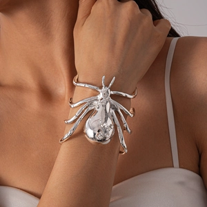 Macro shot of a large silver metallic spider cuff bracelet with sparkling crystal accents