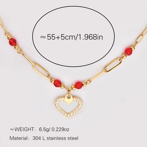 Detail of 18k gold plated stainless steel necklace with red beads and heart pendant