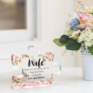 Detail of puzzle-shaped acrylic plaque with rose butterfly patterns and gift text