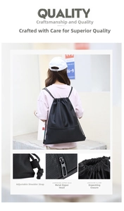 Detail view of black drawstring backpack showing diamond pattern, metal zipper and shoulder strap