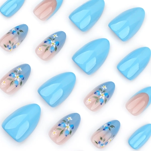 Blue gradient press-on nails with floral designs in long almond stiletto shape