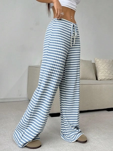 Detail of blue and white striped wide-leg pants with elastic drawstring waist texture