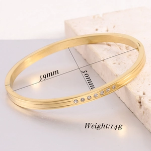Macro view of 18K gold plated oval bangle showing 59mm diameter and 14g weight details