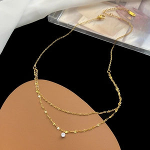 Elegant double-layered gold chain necklace featuring a brilliant round zircon pendant