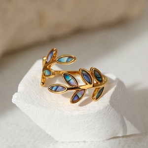 Macro detail of gold adjustable leaf ring with colorful iridescent enamel inlay
