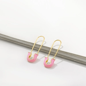 Vibrant pink enamel safety pin earrings with gold metal base for a Y2K aesthetic look