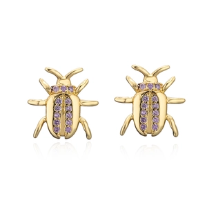 Detailed view of beetle earrings with gold plating and purple zircon stone inlay