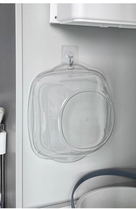 Detailed view of clear plastic washbasin with hanging hole design and wall-mounted hook