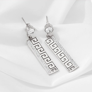Silver drop earrings featuring Greek key pattern with sparkling white rhinestones