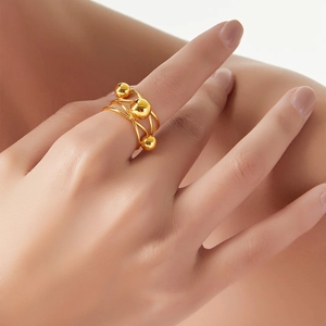 French vintage multilayer gold ring with delicate lines and bead accents on finger