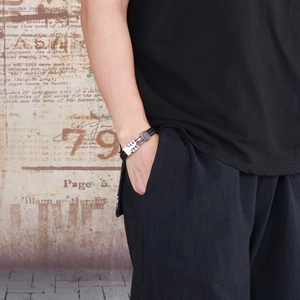 Men's punk leather bracelet with silver metal rivets and magnetic clasp on wrist