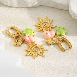 Detailed view of vintage 18K gold plated earrings with sun sunray and floral pendants
