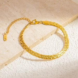 Detailed close-up of 18k gold-plated stainless steel cuban chain with S.Steel engraving