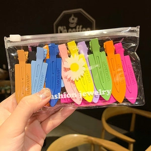 Close-up of colorful matte hair clips set in a clear zipper pouch for daily hair styling