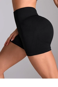 Detailed side view of black seamless high-waisted yoga shorts with ribbed texture fabric