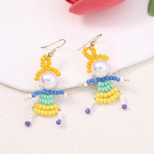 Detailed close-up of handmade beaded earrings with creative cartoon girl doll design