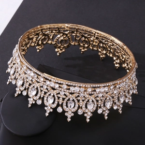 Close-up of golden bridal crown with intricate hollow patterns and sparkling rhinestones