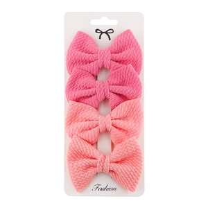 Detailed set of four pink fabric bow hair clips for girls on a white fashion card