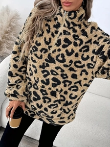 Detail of plush leopard print fleece pullover with quarter zip and cozy texture