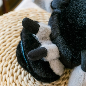 Creative black and white spider plush toy with detailed furry legs on a woven mat