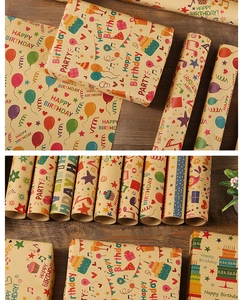 Détail de rouleaux de papier cadeau kraft avec motifs de fête d'anniversaire colorés