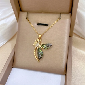 Elegant gold dragonfly necklace with gradient green wings and zircon on gold satin