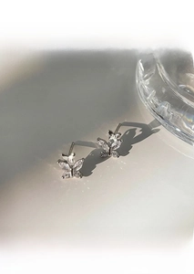 Detail of S999 sterling silver butterfly stud earrings with sparkling cubic zirconia stones