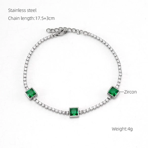 Macro view of stainless steel bracelet with green zircon stones and small white crystals