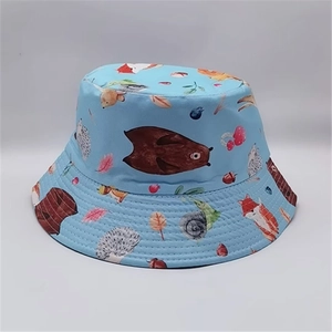 Close-up of light blue bucket hat featuring detailed cartoon forest animal prints