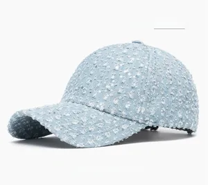 Detail shot of light blue sequins on denim baseball cap with curved brim for women