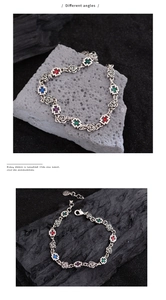 Detailed macro of vintage rose bracelet links with multi-colored gemstone crosses