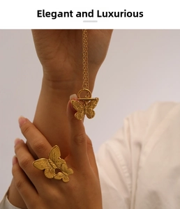Macro view of gold butterfly jewelry set featuring embossed butterfly pendant and open ring