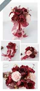 Detailed close-up of wine red and pink bridal silk roses with elegant satin ribbons