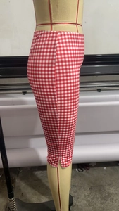 Close-up of slim fit plaid cropped pants featuring a classic red and white checkered pattern