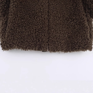 Fashionable dark brown fleece jacket hem detail with high-quality zipper and texture