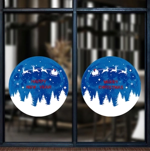 Close-up of blue festive glass window decals with white forest and red merry christmas text