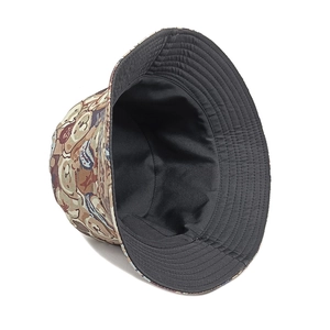 Detail showing cartoon bear pattern jacquard fabric and black lining on wide brim bucket hat