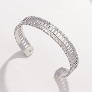 Silver hollow cuff bracelet in stainless steel with geometric patterns and beaded edges