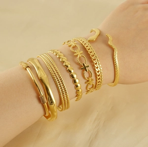 Close-up of 7-piece bohemian gold-plated adjustable bangle and chain bracelet set for women