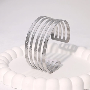 Polished silver stainless steel open bangle with five parallel bands and water drops