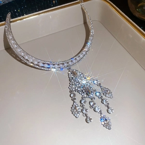 Detail of multi-layer pearl necklace with silver tassels and rhinestones on a tray