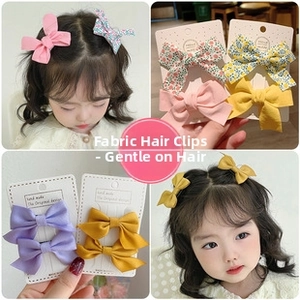 Dettagli fermagli per capelli con fiocco in tessuto, materiale morbido, ideale per bambini.