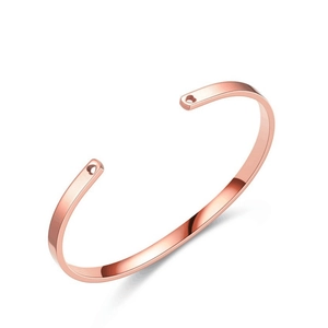 Detailed view of a rose gold stainless steel C-shaped open bracelet on a clean white background
