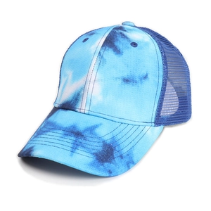 Close-up of blue tie-dye trucker hat showing breathable mesh and cotton texture