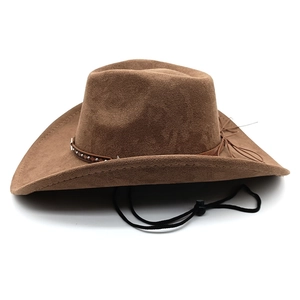 Close-up of brown suede western cowboy hat with studded leather band and adjustable chin strap
