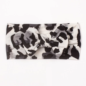 Soft baby headband with classic black and white leopard print and a large bow detail