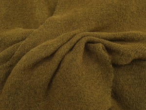 Texture macro de tricot moutarde doux avec détails de fibres et drapé pour cardigan v-neck