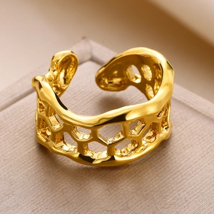 Detailed macro view of gold open ring featuring unique honeycomb hollow pattern and lava edges