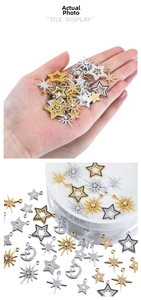 Macro detail of mixed alloy star and moon charms with zircon inlays for DIY jewelry